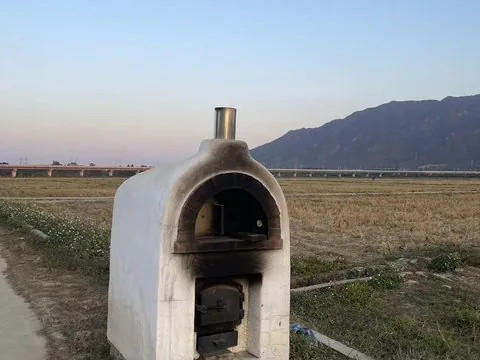 Geo-Sleuth Photo Research — An oven at the edge of a rice paddy, a viaduct and a mountain behind